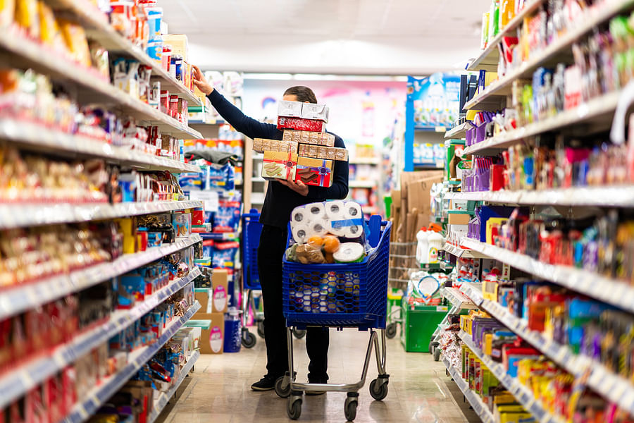 Supermarket shelf filled with a variety of consumer goods